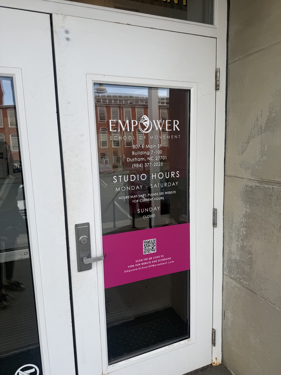 Empower School of Movement storefront hours, logo, and QR signage