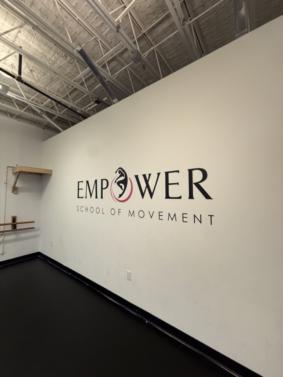 Empower School of Movement logo installed inside the dance studio