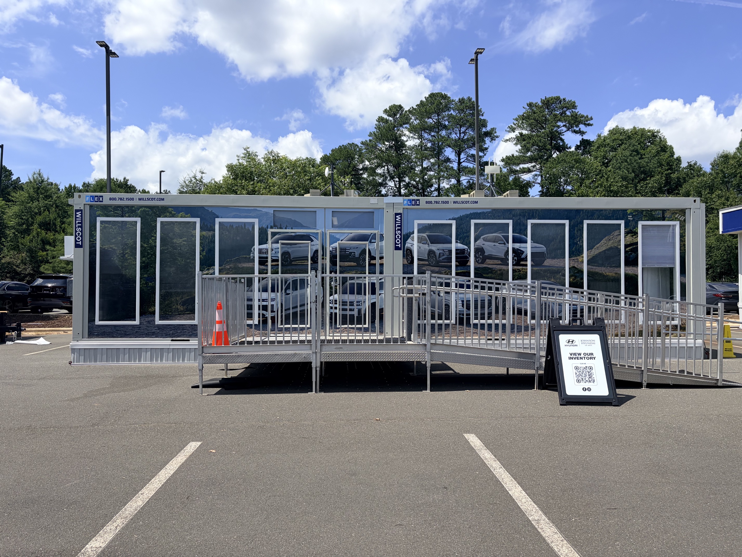 Completed Johnson Hyundai sales trailer wrapped with Hyundai vehicles in a mountain landscape