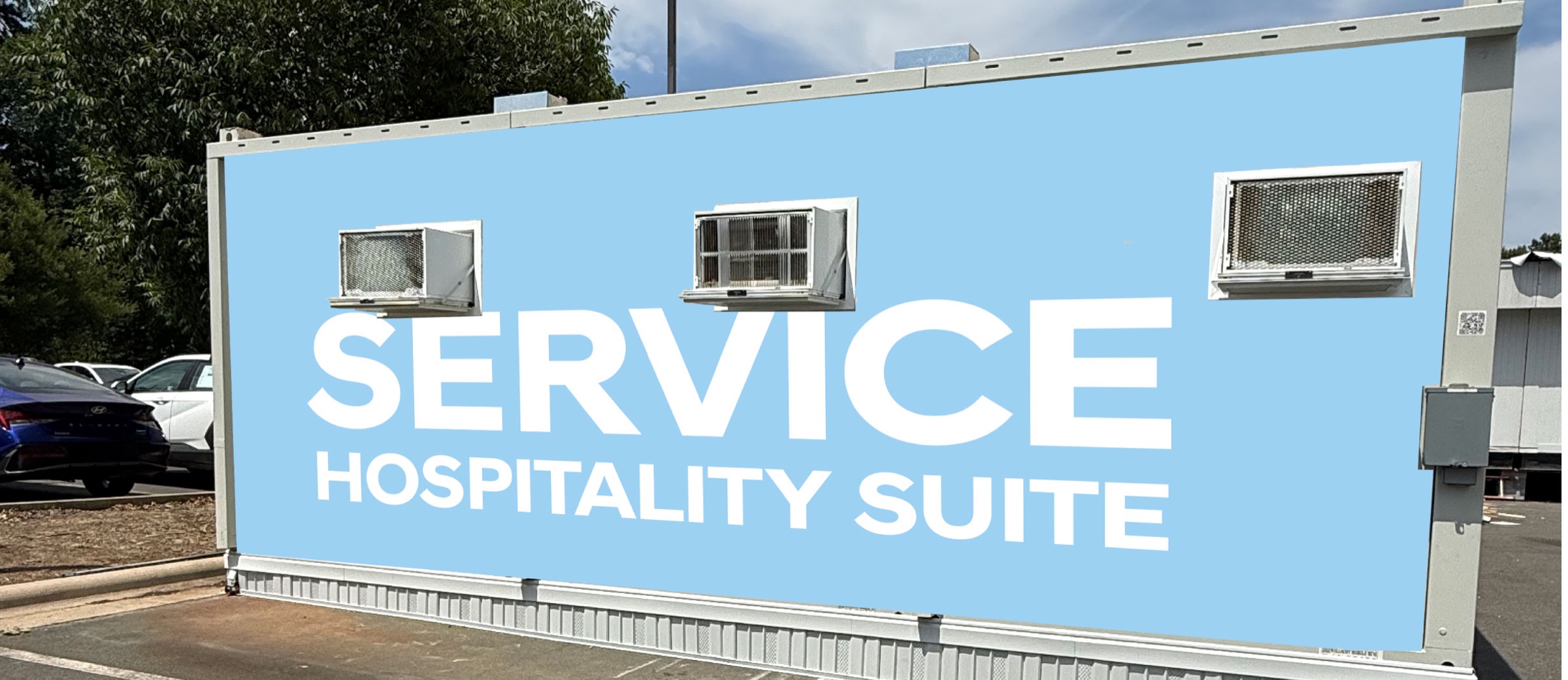 Hyundai trailer service side with oversized white service hospitality suite lettering on blue