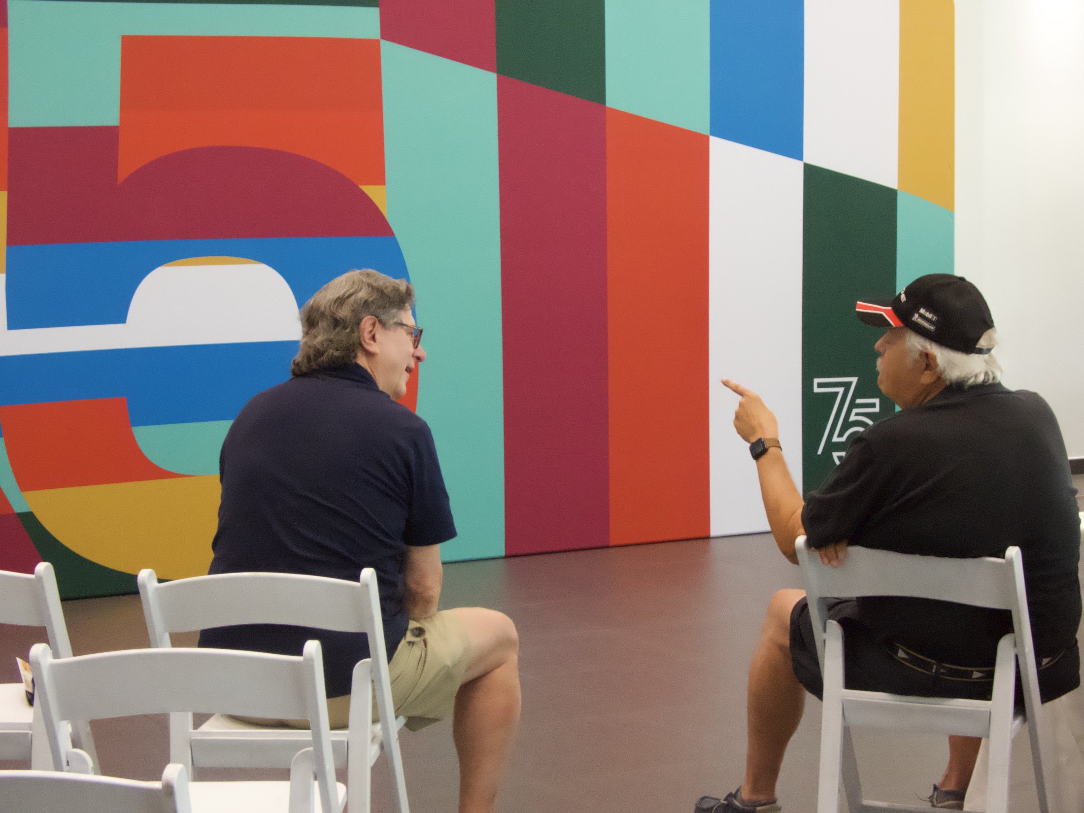 Guests seated in front of the Porsche 75th installation